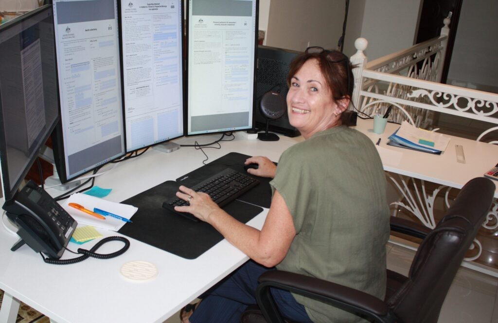 Frances at her desk, Skilled Migration Group